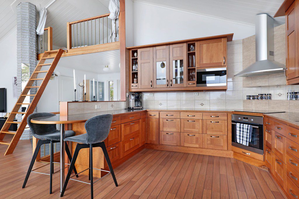 Cozy Scandinavian living with rustic wooden furniture, warm lighting, and snowy mountain views in dreamy northern Sweden home