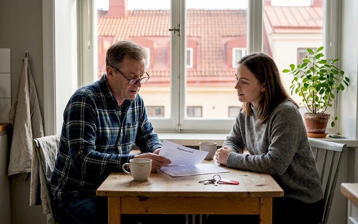 Landlord discussing lease with tenant in apartment