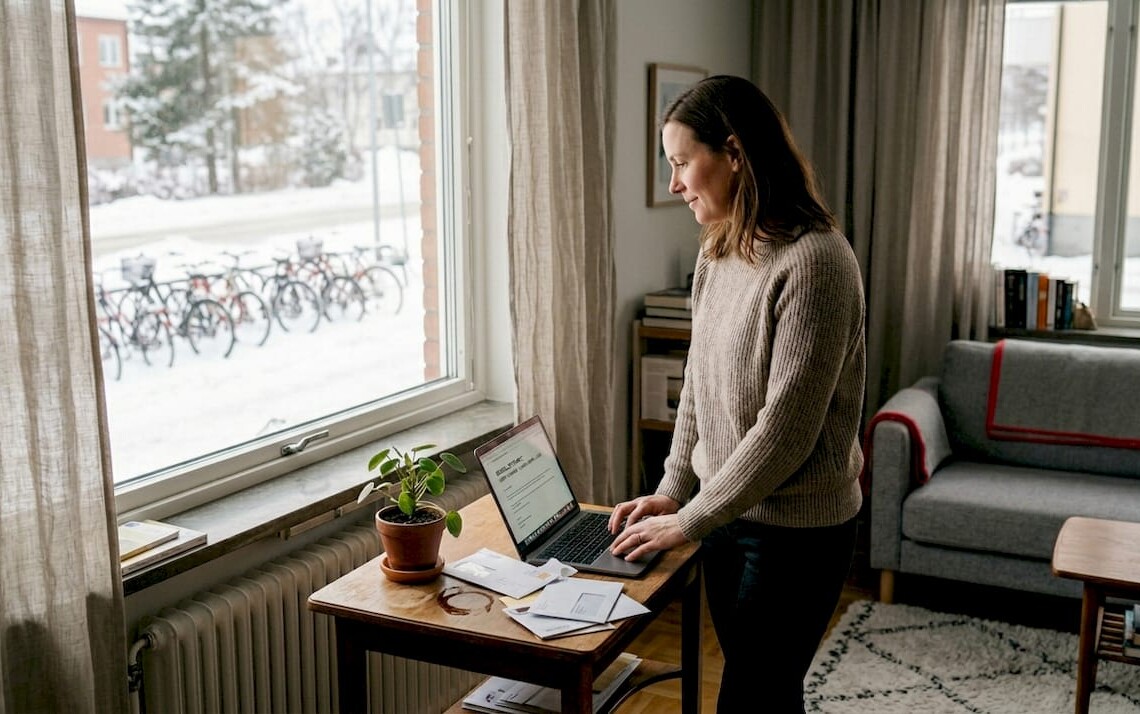 Woman reviewing rental finances in Norrbotten home