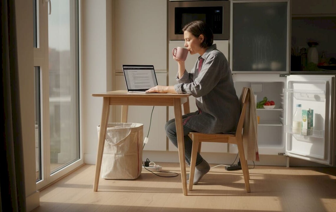 Business traveler using workspace in apartment