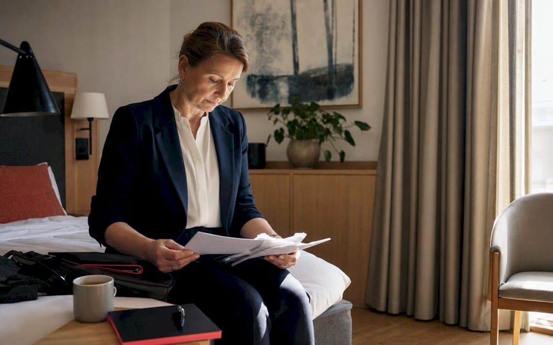 Businesswoman in simple budget hotel room