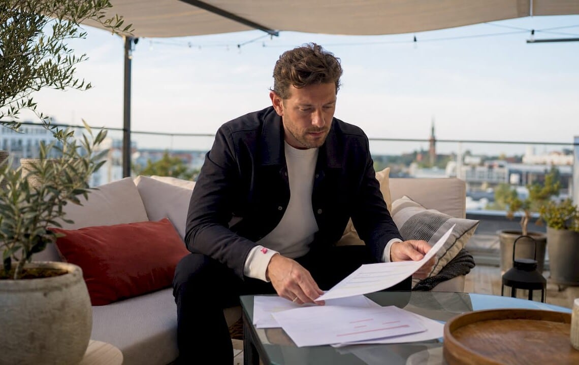 Corporate housing manager reviewing documents in apartment