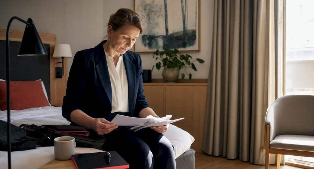 Businesswoman in simple budget hotel room